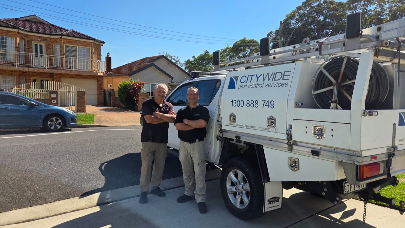 A CITY WIDE technician beside the company van